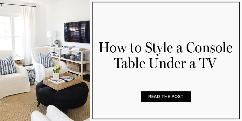 how to style a console table under a TV with coffee table books