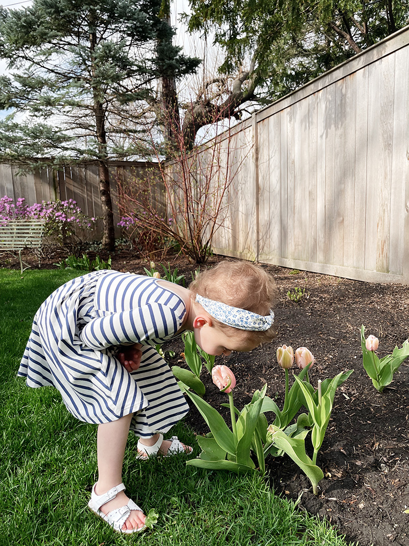 little girl smelling tulips | Working Without Childcare